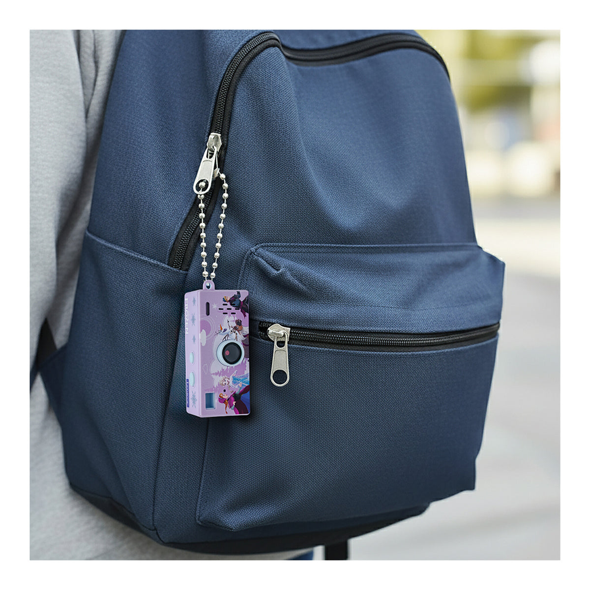 Frozen miniature digital camera keyring attached to a blue backpack