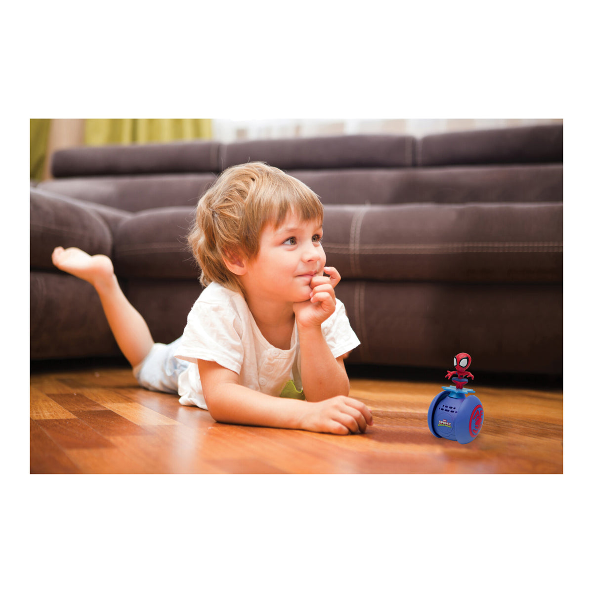 Child lying on the floor watching the Spider-Man robot