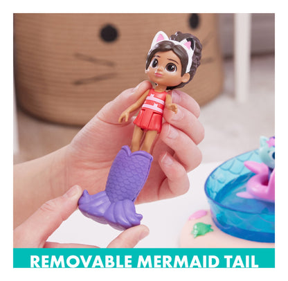 Gabby figure being fitted with the removable purple mermaid tail