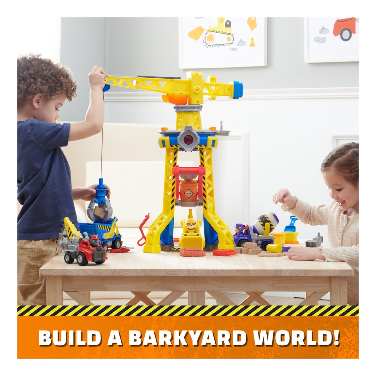 Children playing with Rubble & Crew vehicles and a Bark Yard tower playset