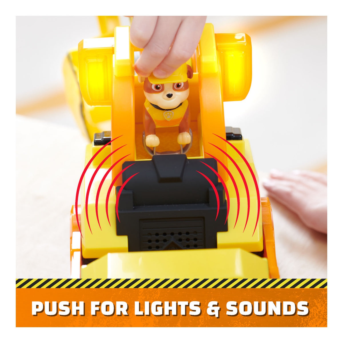 Rubble figure being pressed into the bulldozer seat to activate lights and sounds