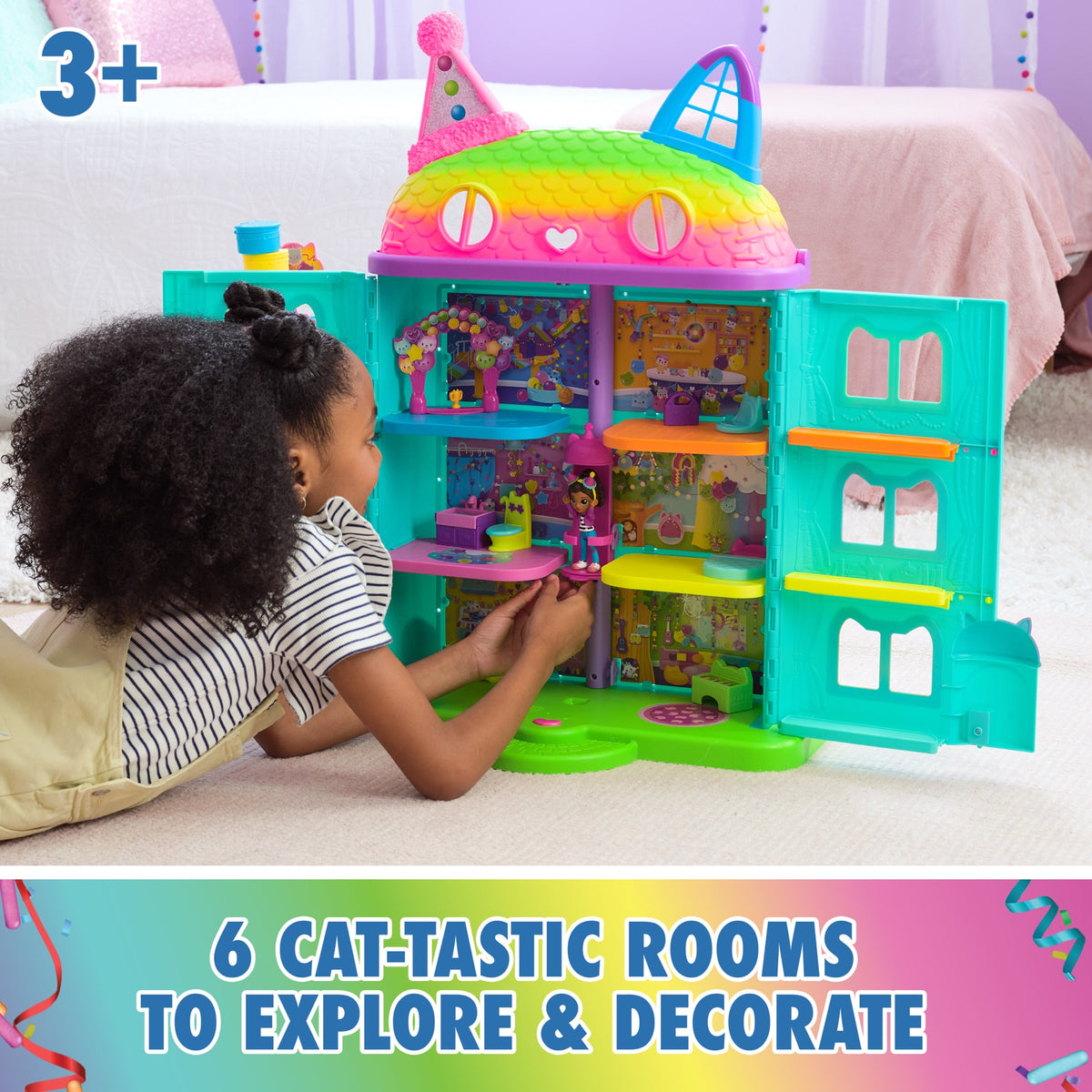 Child playing inside the open six-room Gabby's Dollhouse playset