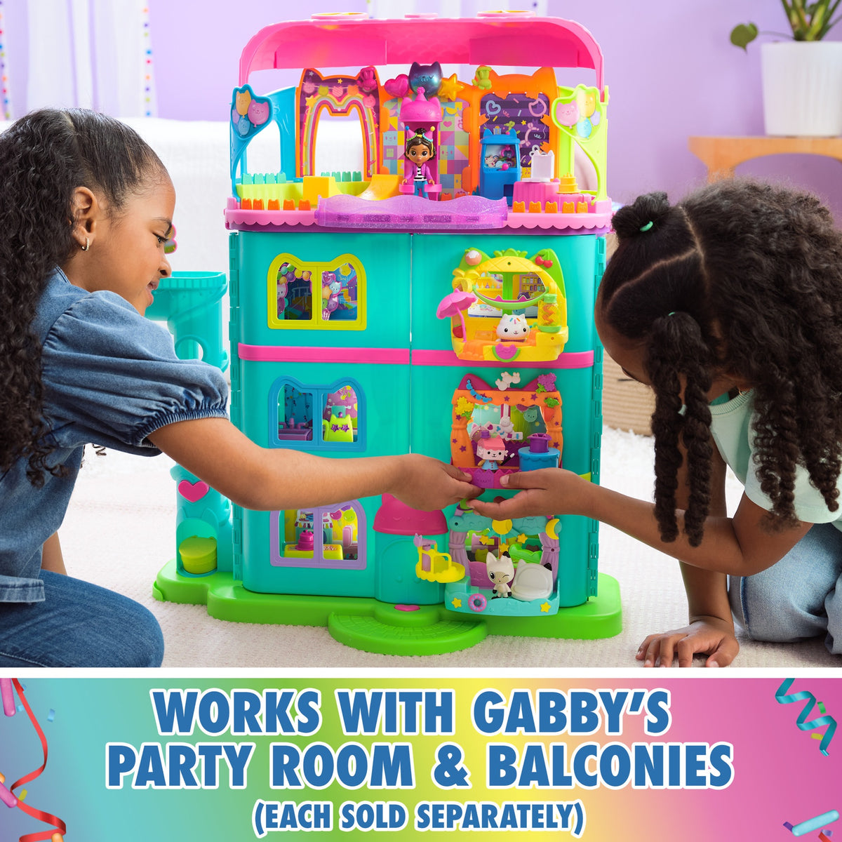 Children playing with the dollhouse fitted with separately sold room extensions