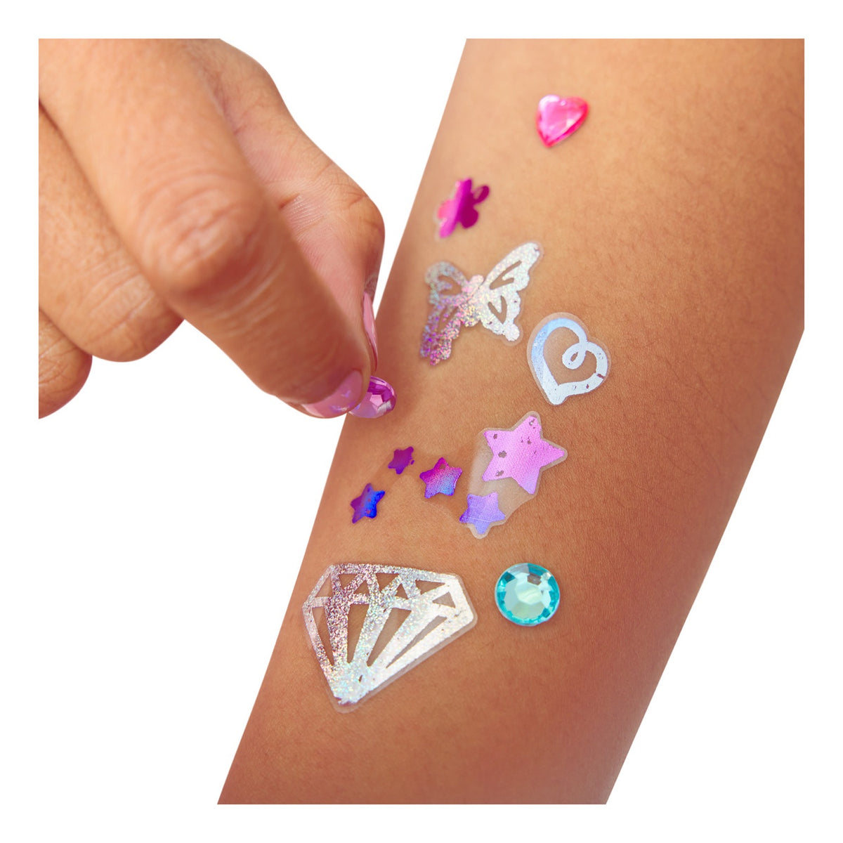 Shimmer Me foil tattoos and gems applied to an arm