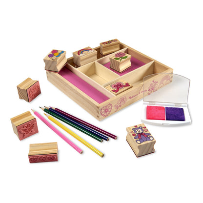 Friendship wooden stamps, pencils and ink pad arranged around the storage tray