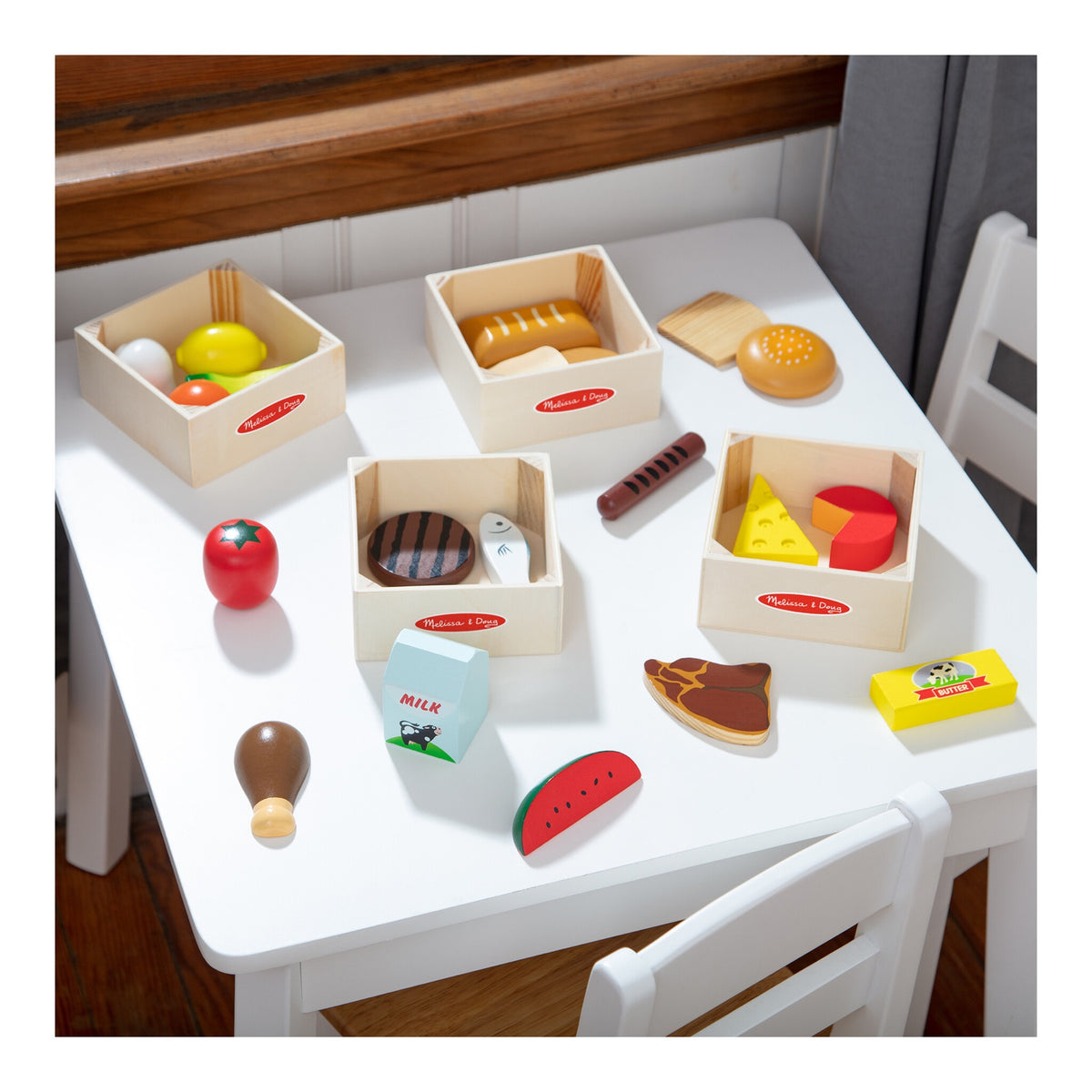 Wooden food group playset arranged on a child's table