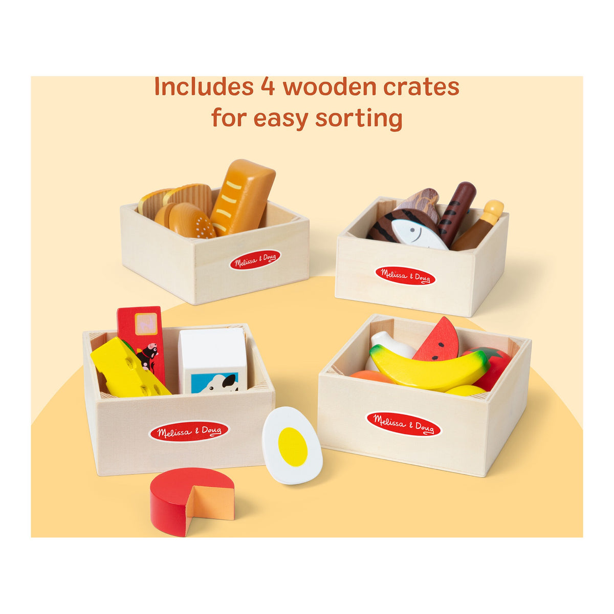 Four wooden crates filled with food group play pieces for easy sorting