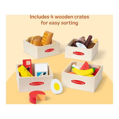 Four wooden crates filled with food group play pieces for easy sorting