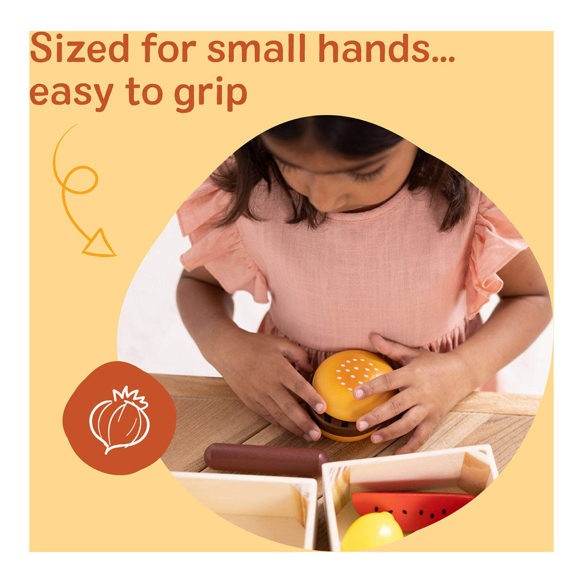 Child holding a wooden toy burger designed for small hands