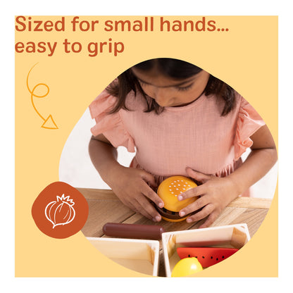 Child holding a wooden toy burger designed for small hands