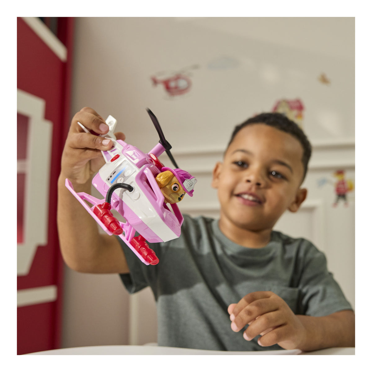Child flying the Skye rescue helicopter toy during play