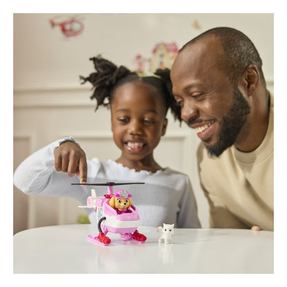 Child and parent playing with Skye's helicopter and cat figure