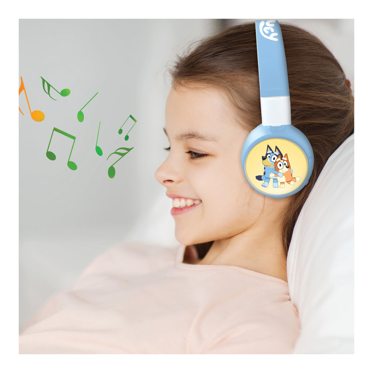 Girl relaxing while wearing Bluey wireless headphones