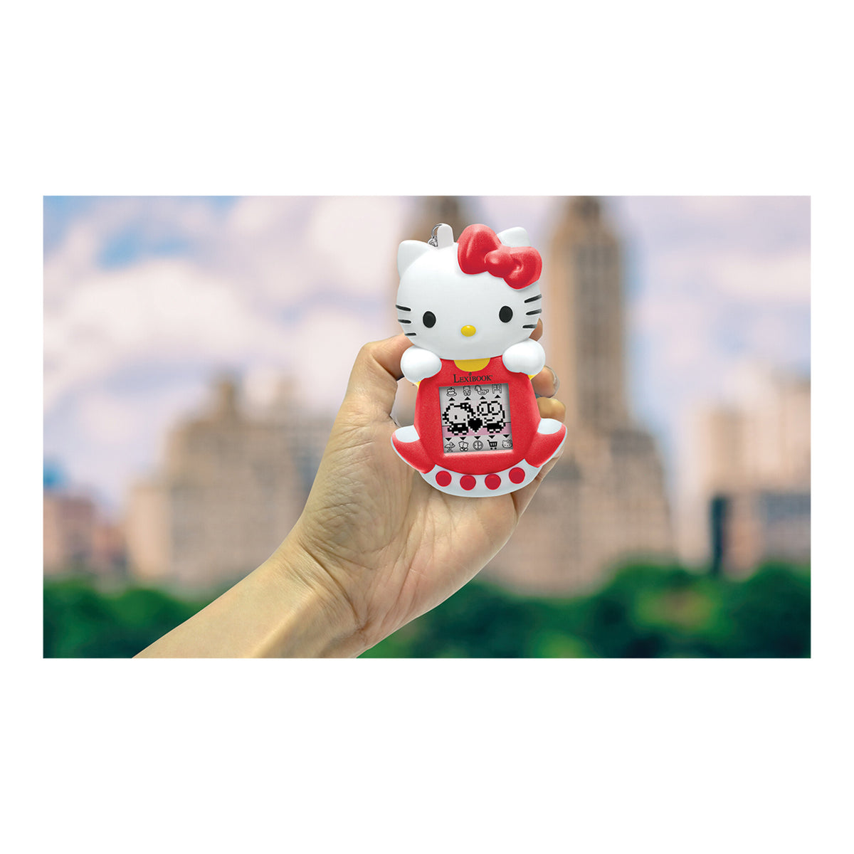 Hello Kitty virtual pet game held in one hand outdoors