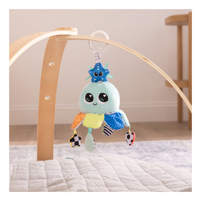 Salty Sam stroller toy hanging from a wooden baby play gym