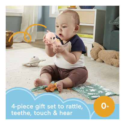 Baby playing with the four-piece Sensimals newborn gift set