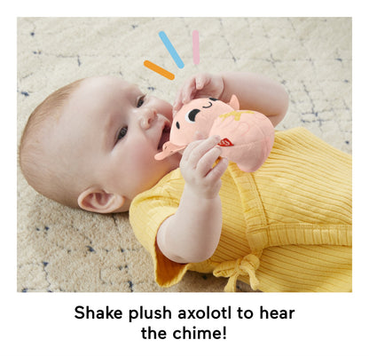 Baby shaking the pink Sensimals axolotl chime toy