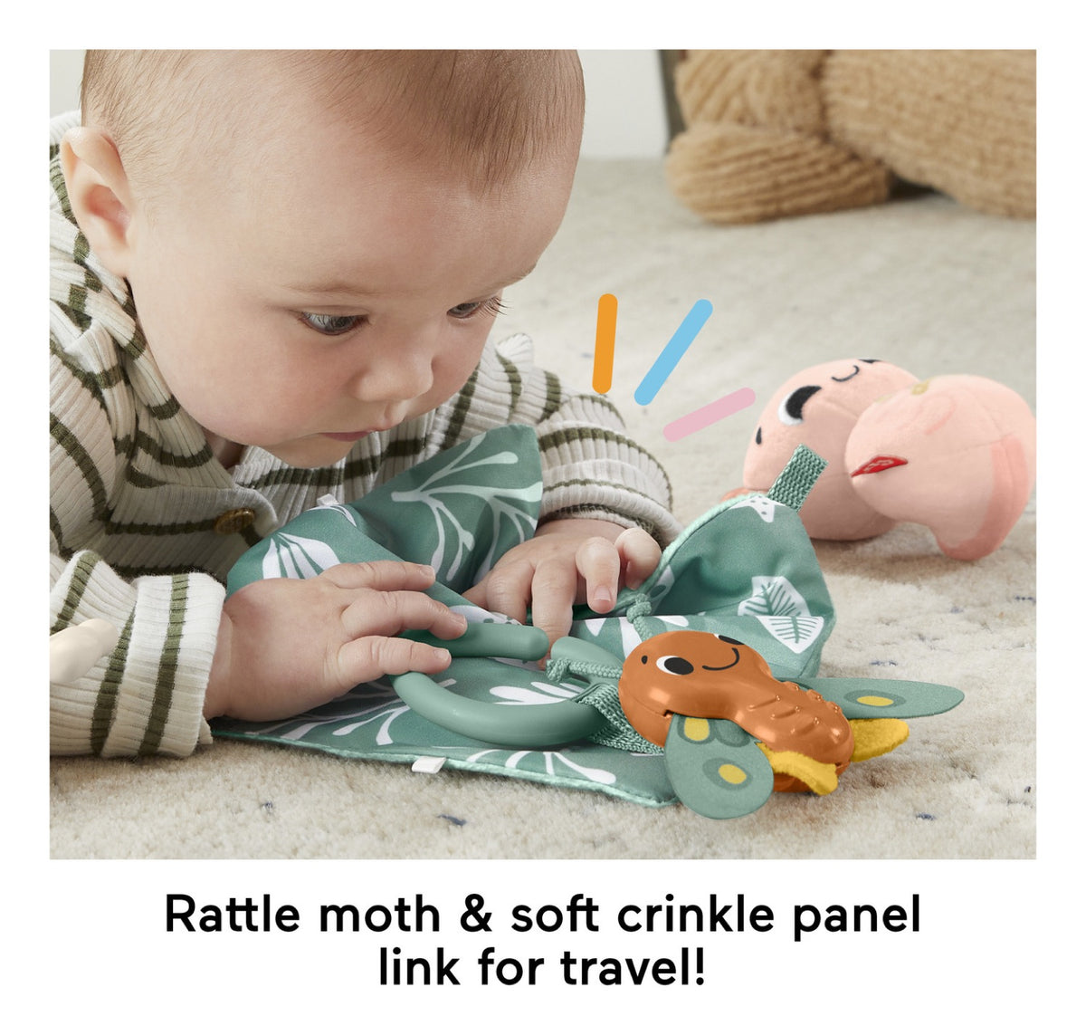 Baby playing with the Sensimals moth rattle and crinkle panel