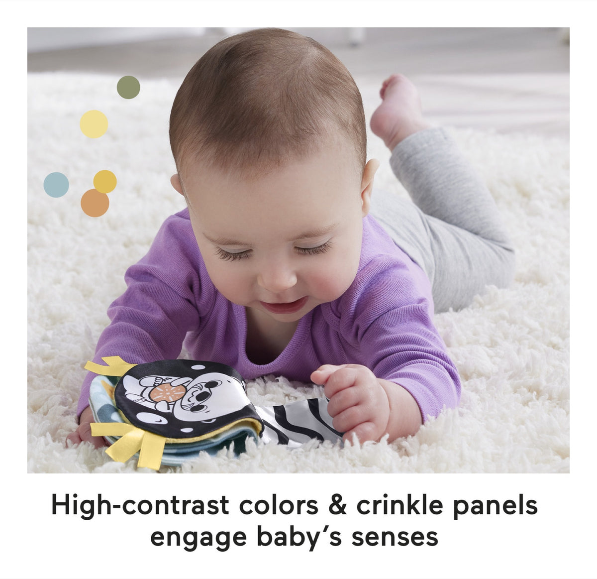 Baby exploring the high-contrast crinkle panel during tummy time